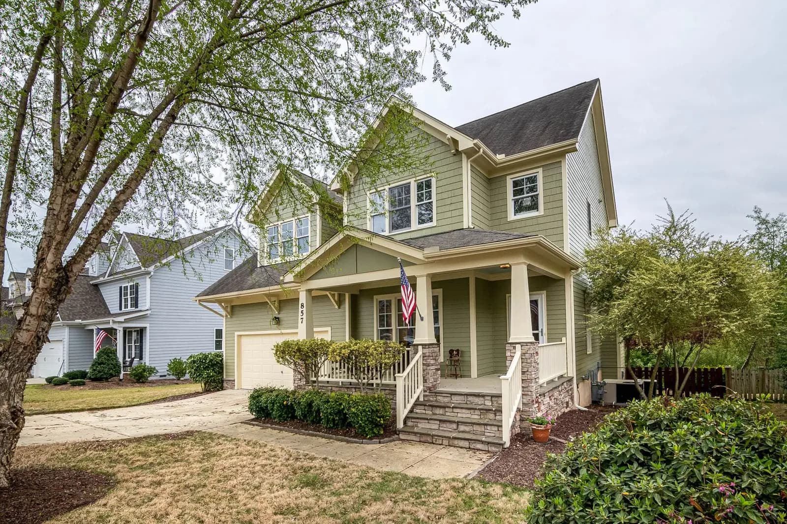 A well-kept home with a front porch in a community neighborhood