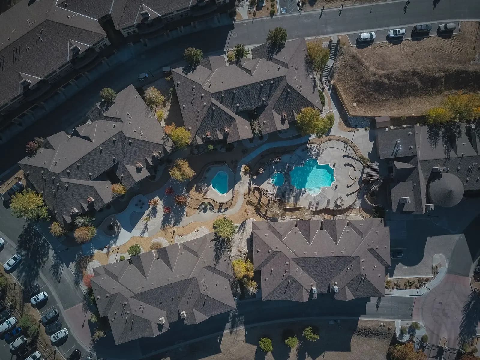 Aerial view of a residential community with shared pools — what association dues maintain